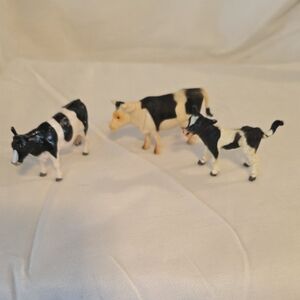 Trio of Black and White Cow Figurines